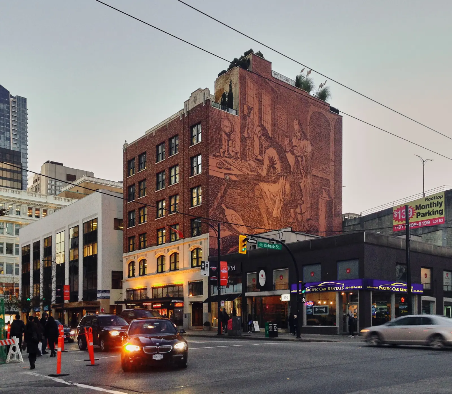 Vancouver's six-story mural at 555 West Georgia, depicting three goldsmiths working in their workshop, painted over during renovations in January 2024.