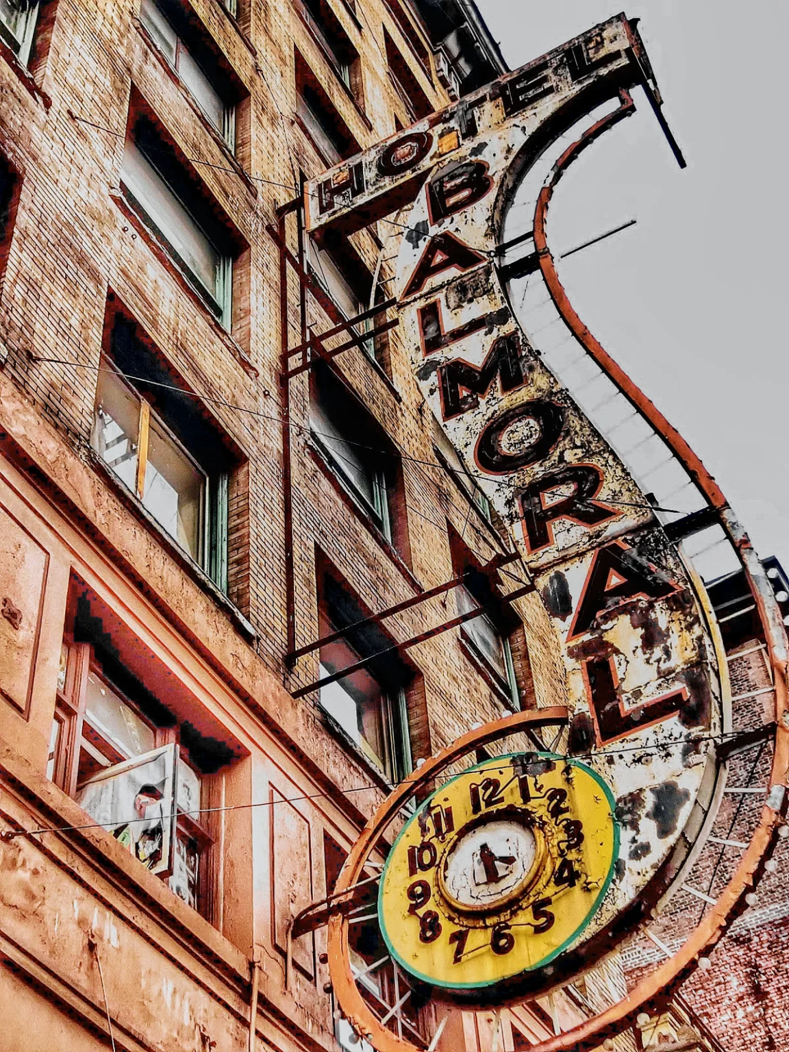 Historic Balmoral Hotel in Vancouver with its iconic neon blade sign, before demolition in 2024, symbolizing the end of an era.