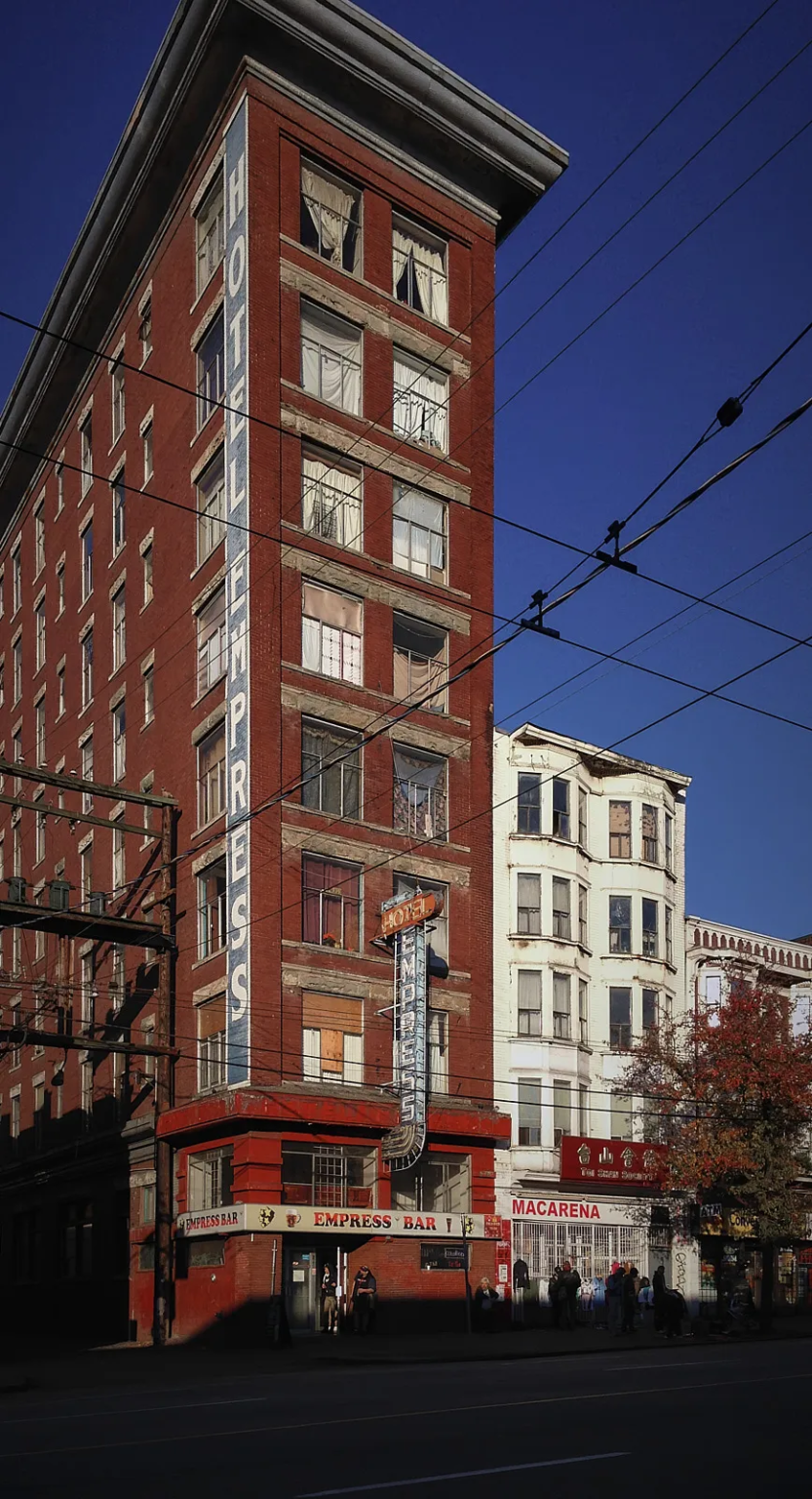 Hotel Empress at 235 East Hastings Street, Vancouver, an iconic eight-story Edwardian building with a prominent painted sign on the west facade.